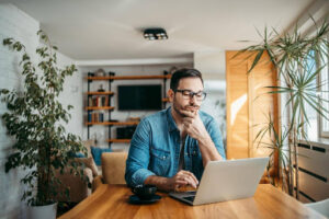 Business owner thinking about whether he should outsource bookkeeping or not.